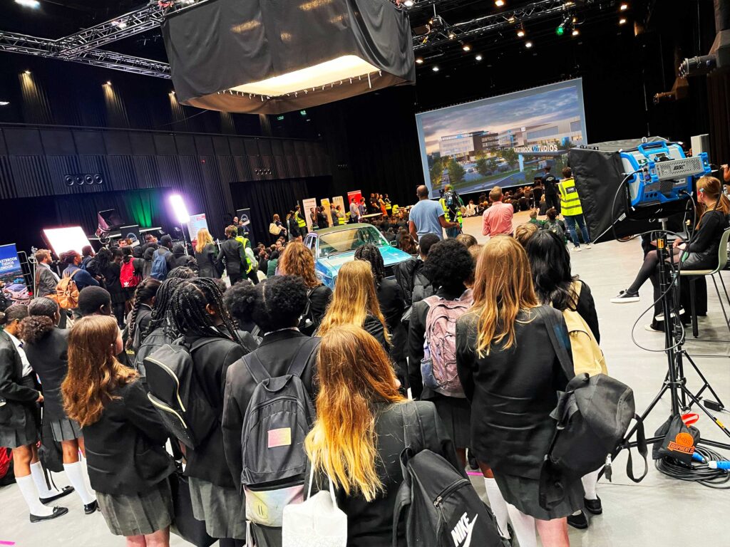 Young children are looking at a screen in a film studio