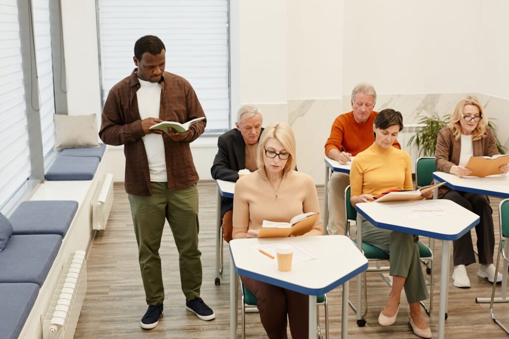 Teacher giving lecture for adult students at class